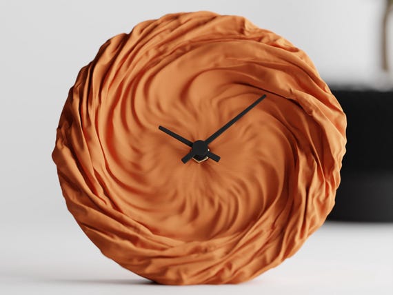 Front close-up of the orange DrapedHour Wall Clock