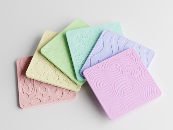 Overhead close-up of the fixed Patchpetal Coaster Set pastel assortment arranged to show every pattern