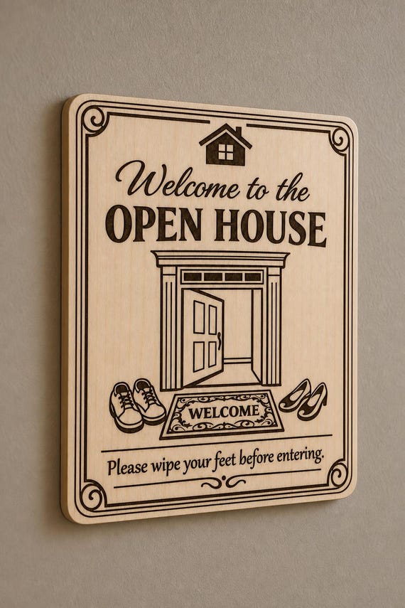 GrandEntry engraved birch open-house wipe-feet sign mounted on a neutral wall from a close side angle.