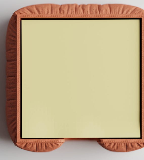 Top close-up of the MemoNook Pad Holder holder with a square sticky note pad for scale