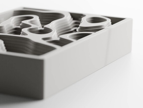 Right three-quarter close-up of the Mapwell Organizer Tray tray's raised rim and stepped interior