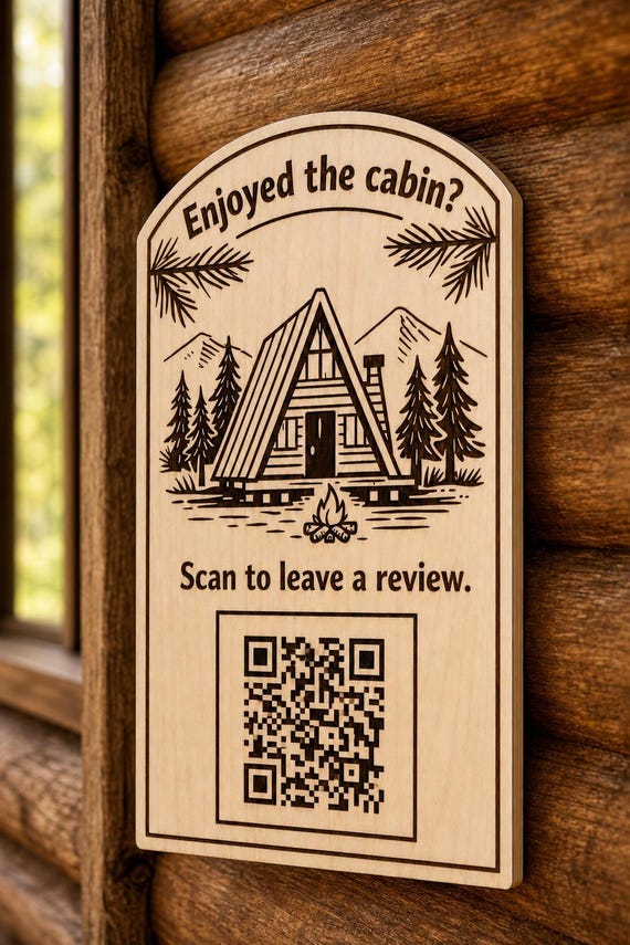 TimberPeak engraved birch cabin review sign mounted on a warm wall from a close side angle with a finished sample QR code.