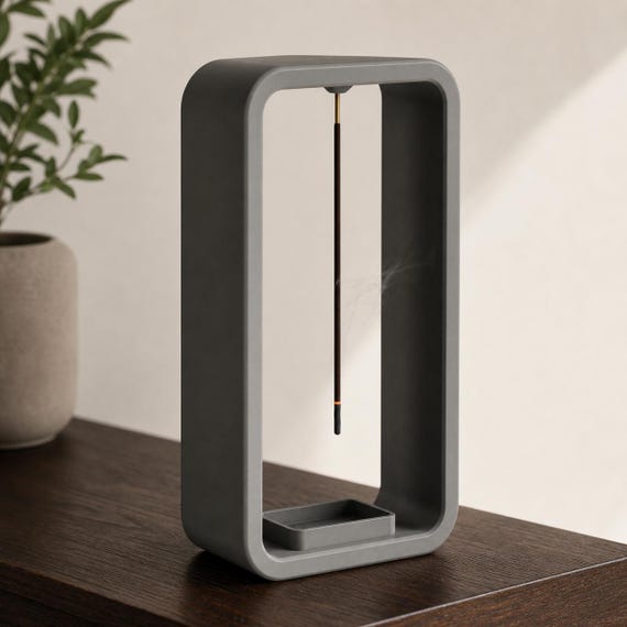 Three-quarter close-up of a Dark Grey EmberLift Incense Stand incense stand on a walnut console