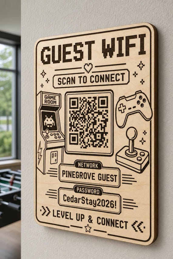 Pixel Lounge Guest WiFi Sign engraved birch sign mounted on a realistic neutral interior wall from a close side angle in natural birch and dark engraving, showing the QR code and guest network details.