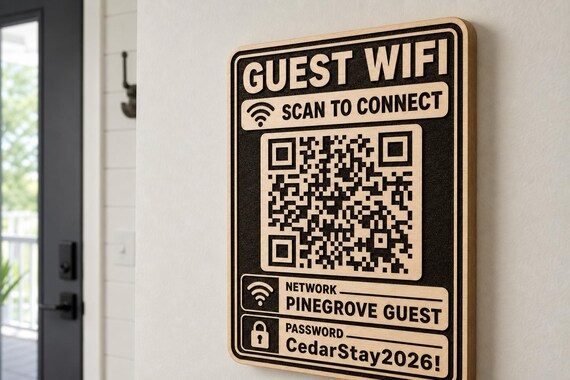 Bold Connect Guest WiFi Sign engraved birch sign mounted on a realistic neutral interior wall from a close side angle in natural birch and dark engraving, showing the QR code and guest network details.