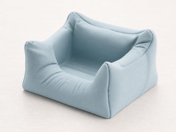 High-angle close-up of the Ice Blue Plush Nook stand showing its four corners and recessed seat