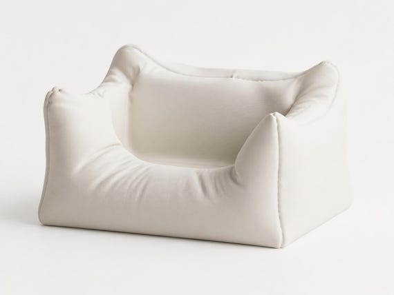 Front three-quarter close-up of the empty Plush Nook phone stand in Ivory White