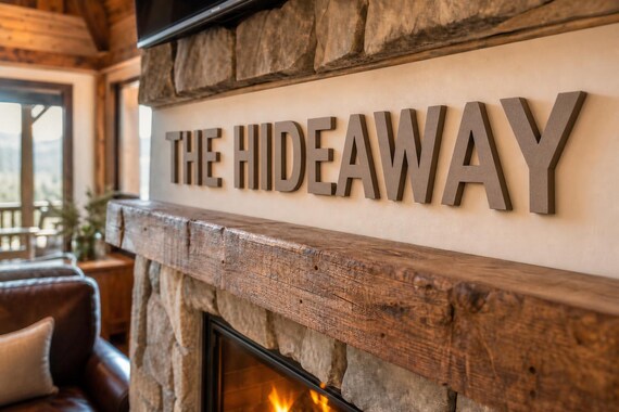 HavenMark Raised Letter Set spelling The Hideaway above a cabin fireplace from a close side viewpoint.