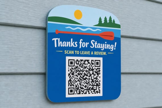 PaddleBright multicolor lake guest review sign mounted on a pale blue wall from a close side angle with a finished sample QR code.