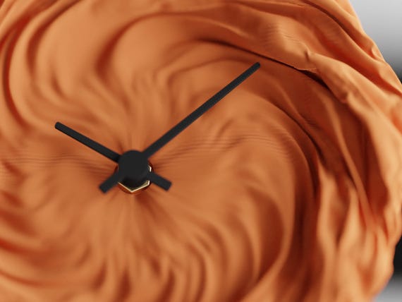 Detail view of the DrapedHour Wall Clock clock face with black hands and gold center pin