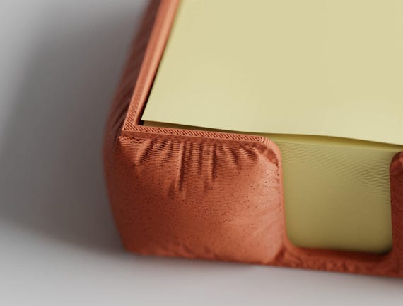 Front detail of the MemoNook Pad Holder note holder showing its low sheet-access opening