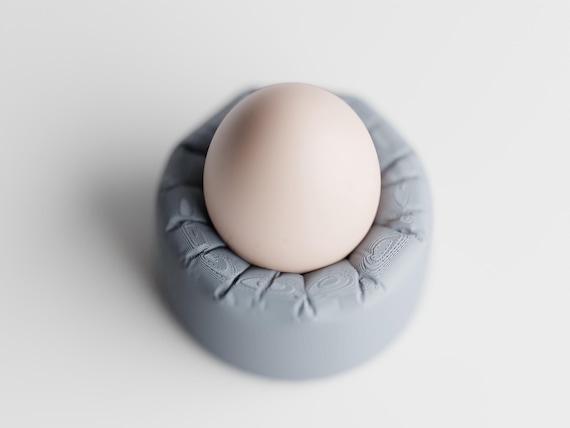High-angle close-up of the Morningswell Egg Cup egg cup and rounded cushion-look rim