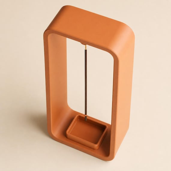 High-angle close-up of a Pumpkin Orange EmberLift Incense Stand