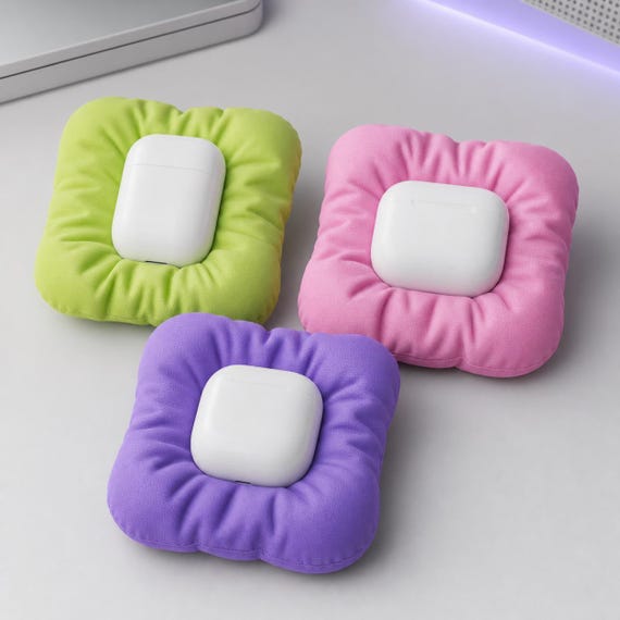 Close-up of three PuffNest docks in Apple Green, Sakura Pink, and Lilac Purple with different case shapes