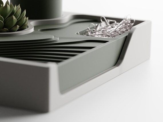 Right-side close-up of the Landform Desk Station catchall tray, low round well, and sculpted front opening