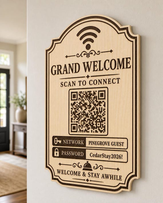 Grand Welcome Guest WiFi Sign engraved birch sign mounted on a realistic neutral interior wall from a close side angle in natural birch and dark engraving, showing the QR code and guest network details.
