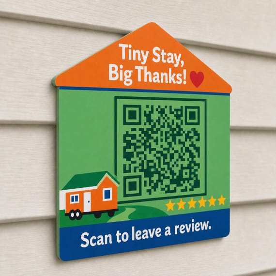 TinyHaven multicolor tiny-home review sign mounted on a light neutral wall from a close side angle with a finished sample QR code.