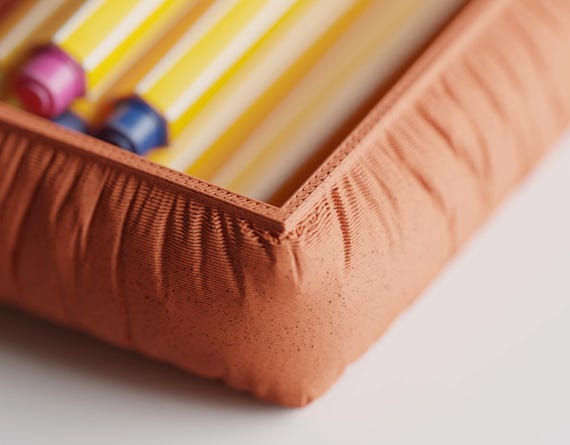 Close-up of the StudioSwell Organizer Set accessory tray showing its gathered fabric-look texture