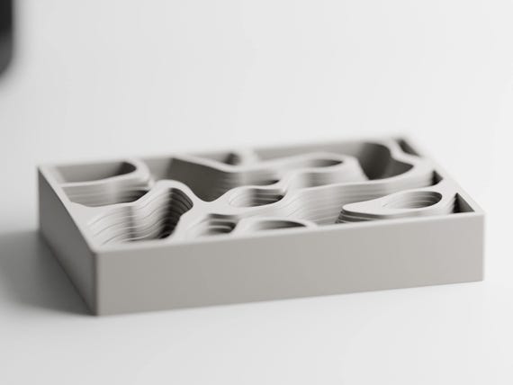 Front three-quarter view of the empty Mapwell Organizer Tray sculptural desk and jewelry organizer