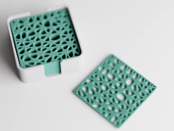 Overhead close-up of the Fernwork Coaster Set botanical lattice pattern and coordinating holder