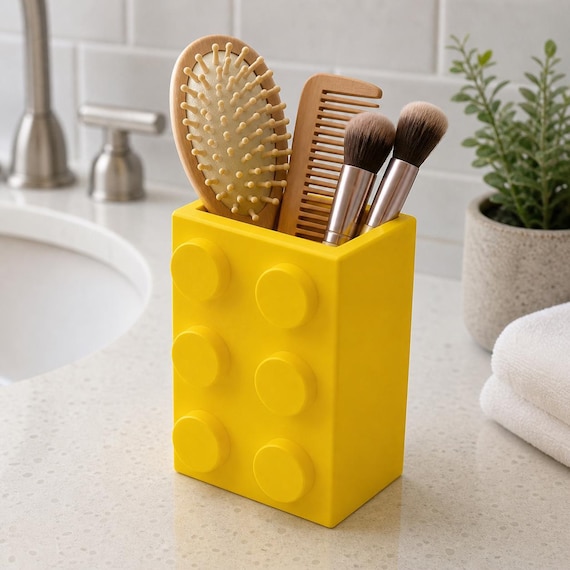 Yellow large-opening bathroom organizer holding brushes and a comb