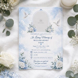 May include: A rectangular memorial service invitation card featuring a light blue sky background with white clouds, two white doves, and blue and white floral arrangements. The text includes "In Loving Memory of WILLIAM HENRY DAVIS" and details.