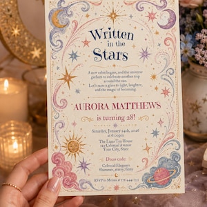 May include: A rectangular birthday invitation card featuring celestial illustrations of moons, stars, a sun, and a planet. The text reads Written in the Stars, Aurora Matthews is turning 28, Saturday, January 24th, 2026, at 6:00pm, The Luna Tea House.