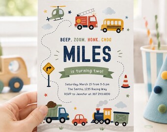 May include: A rectangular birthday invitation card featuring colorful illustrations of a helicopter, fire truck, school bus, dump truck, car, and train. The text reads BEEP. ZOOM. HONK. CHOO, MILES is turning two!, Saturday, March 15 from 3-5 pm, The Smiths, 1235 Racing Way, RSVP to Jennifer at 307.293.6830.