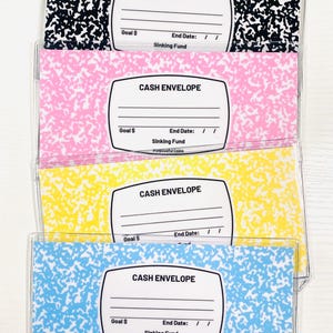 May include: Four clear plastic cash envelopes with colorful composition notebook style patterns in black, pink, yellow, and blue. Each envelope features a white label printed with "CASH ENVELOPE," "Goal $", "End Date: / /", and "Sinking Fund".