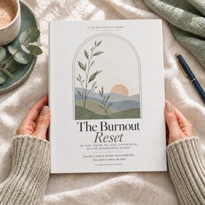 May include: A white book titled The Burnout Reset, A 30-Day Gentle Reset. The cover features an arched illustration of a sun over rolling hills and leafy branches in muted green, blue, and peach tones. Subtitle text reads 30-Day Guide to Less Overwhelm, Better Boundaries & Rest.
