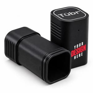 May include: Two black rectangular containers with rounded corners. One container is upright with the text Tübr on the top and YOUR DESIGN HERE in red on the side. The other container is lying horizontally with an open end showing a hollow interior.