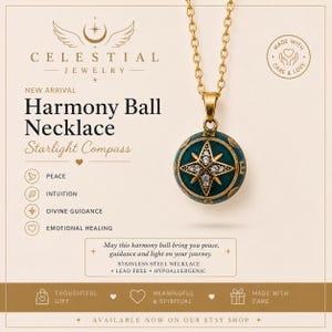 May include: A gold-toned chain necklace featuring a spherical pendant with a teal enamel finish and a central gold star motif accented with clear crystals. The pendant displays compass-like markings and text including Celestial Jewelry and Harmony Ball.