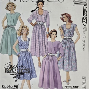 May include: Vintage McCall's sewing pattern featuring illustrations of dresses. The pattern includes a variety of dress styles, with details like collars, belts, and pockets. The cover displays the text "Fashion Basics" and "Cut-to-Fit".