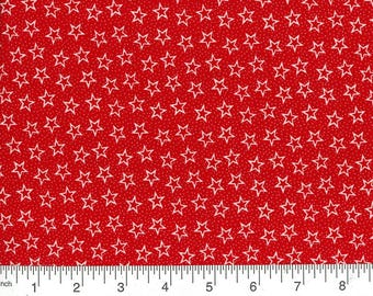 May include: Red fabric with a white star pattern. The fabric is measured with a ruler in inches.