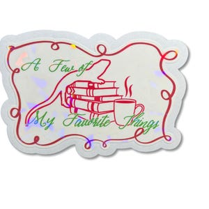May include: A holographic sticker with a red decorative border featuring a lizard perched on a stack of books next to a steaming mug. The text reads A Few of My Favorite Things in green script. The background has a reflective, iridescent finish.