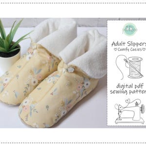 May include: A pair of adult slippers with a floral pattern in yellow, pink, and blue. The slippers have a white, plush lining and are next to a small potted plant. The image also includes a digital PDF sewing pattern.
