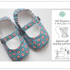 May include: A pair of blue Mary Jane style kid slippers with a repeating pink and white circle pattern. The slippers have a strap with a button closure and a ruffled edge. The image also includes text that says "Kid Slippers Mary Janes" and "digital pdf sewing pattern."