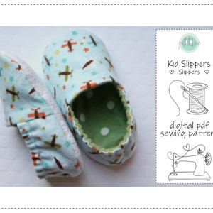 May include: A pair of kid's slippers with a light blue airplane and star pattern. The interior is green with white polka dots. The image also includes a digital PDF sewing pattern for the slippers.