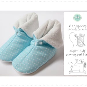 May include: Two light blue children's slippers with white polka dots and a white, fluffy lining. The slippers have a button fastening. A graphic on the right shows a sewing pattern for the slippers, with the text "Kid Slippers Comfy Cozies" and "digital pdf sewing pattern."