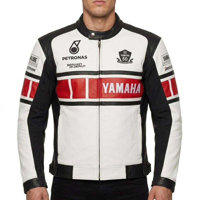 May include: A white, black, and red motorcycle jacket featuring the Yamaha logo, Petronas branding, and a 50th anniversary emblem. The jacket has a mandarin collar with a snap button, a full-length front zipper, and long sleeves with black panels.