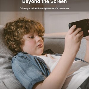 May include: A digital book cover titled Beyond the Screen with the subtitle Calming activities from a parent who's been there. The image features a person with curly brown hair wearing a blue shirt and white t-shirt holding a black smartphone.