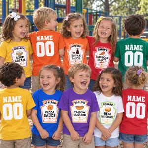 May include: A collection of children wearing colorful t-shirts featuring various condiment and food labels like Sour Cream, Teriyaki Sauce, Barbeque Sauce, Pizza Sauce, Yellow Mustard, and Mayonnaise, with custom name and number prints on the back.