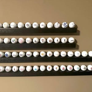Golf ball display shelf with floating shelf hardware.