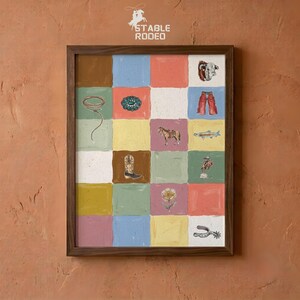 May include: A framed wall art print featuring a grid of twenty colorful squares, each containing a small illustration related to western themes, including a lasso, turquoise concho, cowboy boots, a horse, a bull skull, and a spur, with the text STABLE RODEO.