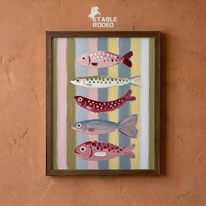 May include: A framed painting featuring five stylised fish stacked vertically against a background of vertical stripes in shades of pink, yellow, and grey. The fish are rendered in pink, white, and blue tones with visible brushstrokes. The text STABLE RODEO is visible at the top.