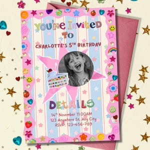A colorful birthday invitation sits on a surface sprinkled with gold star confetti and shiny heart decorations. The card has a bright pink border covered in playful stickers like smiley faces, strawberries, rainbows, and flowers. A black‑and‑white photo of a smiling child appears inside a pink star, with a cute birthday cake illustration below. Soft pastel blue‑and‑white stripes create a cheerful, whimsical backdrop.
