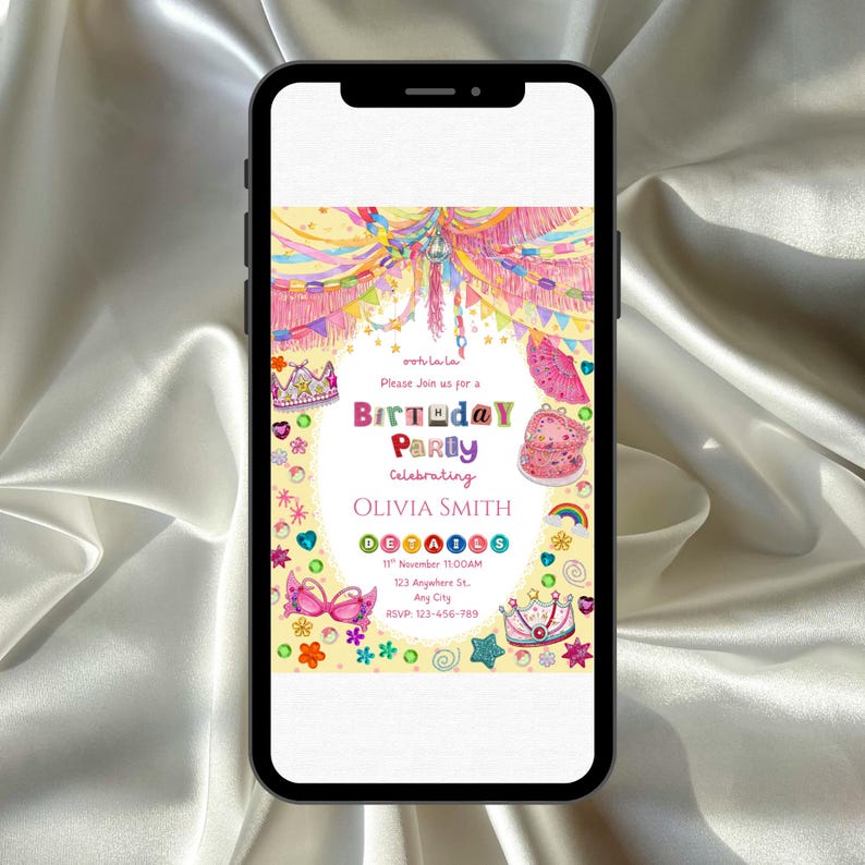 A Fancy Nancy–style birthday invitation displayed on a smartphone, glowing against silky fabric. The design bursts with colorful glitter‑like crowns, hearts, stars, flowers, and bright streamers in pink, yellow, purple, and blue. It feels whimsical, glamorous, and festive, celebrating Olivia Smith with a joyful, sparkly party aesthetic.
