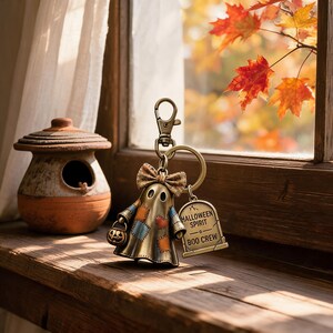 Cute Halloween Ghost Keychain with Patchwork Dress and Pumpkin Lantern Perfect for Trick-or-Treaters or Collectors