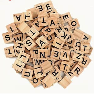 May include: A pile of wooden Scrabble tiles with black letters and numbers. The tiles are light brown and square-shaped, with various letters and point values visible. The letters include A, E, I, O, U, S, T, L, N, R, and more.