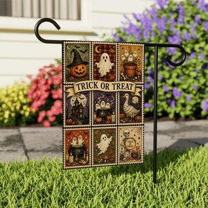 May include: A rectangular garden flag hanging on a black metal stand, featuring nine grid-style panels with Halloween illustrations including a jack-o'-lantern, ghosts, a haunted house, a goose, and a skeleton, with the text TRICK OR TREAT in the center.